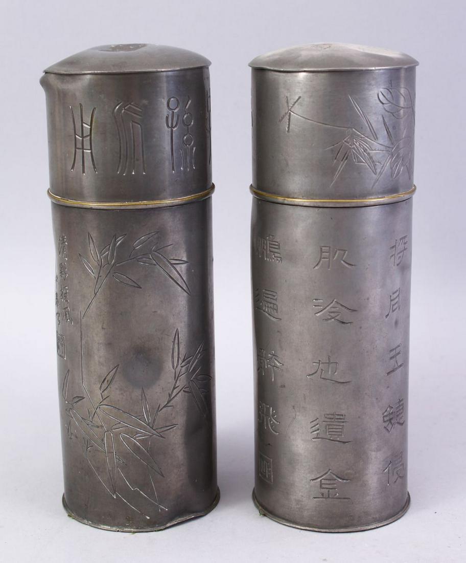 A PAIR OF 19TH / 20TH CENTURY CHINESE PEWTER DRINKING: A PAIR OF 19TH / 20TH CENTURY CHINESE PEWTER DRINKING FLASKS, the body of each carved with calligraphy and bamboo decoration, 23cm high.
