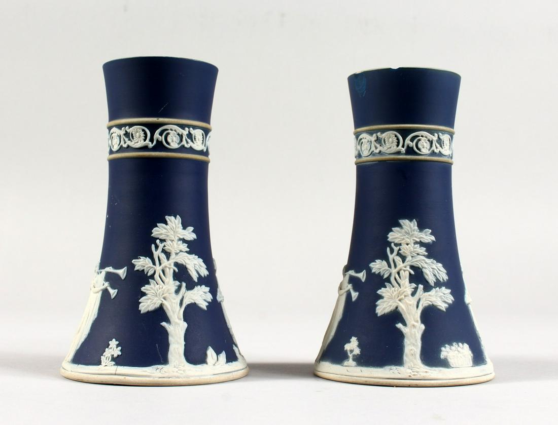 A PAIR OF ADAM'S BLUE AND WHITE JASPER WARE SPILL: A PAIR OF ADAM'S BLUE AND WHITE JASPER WARE SPILL VASES. 6ins high.