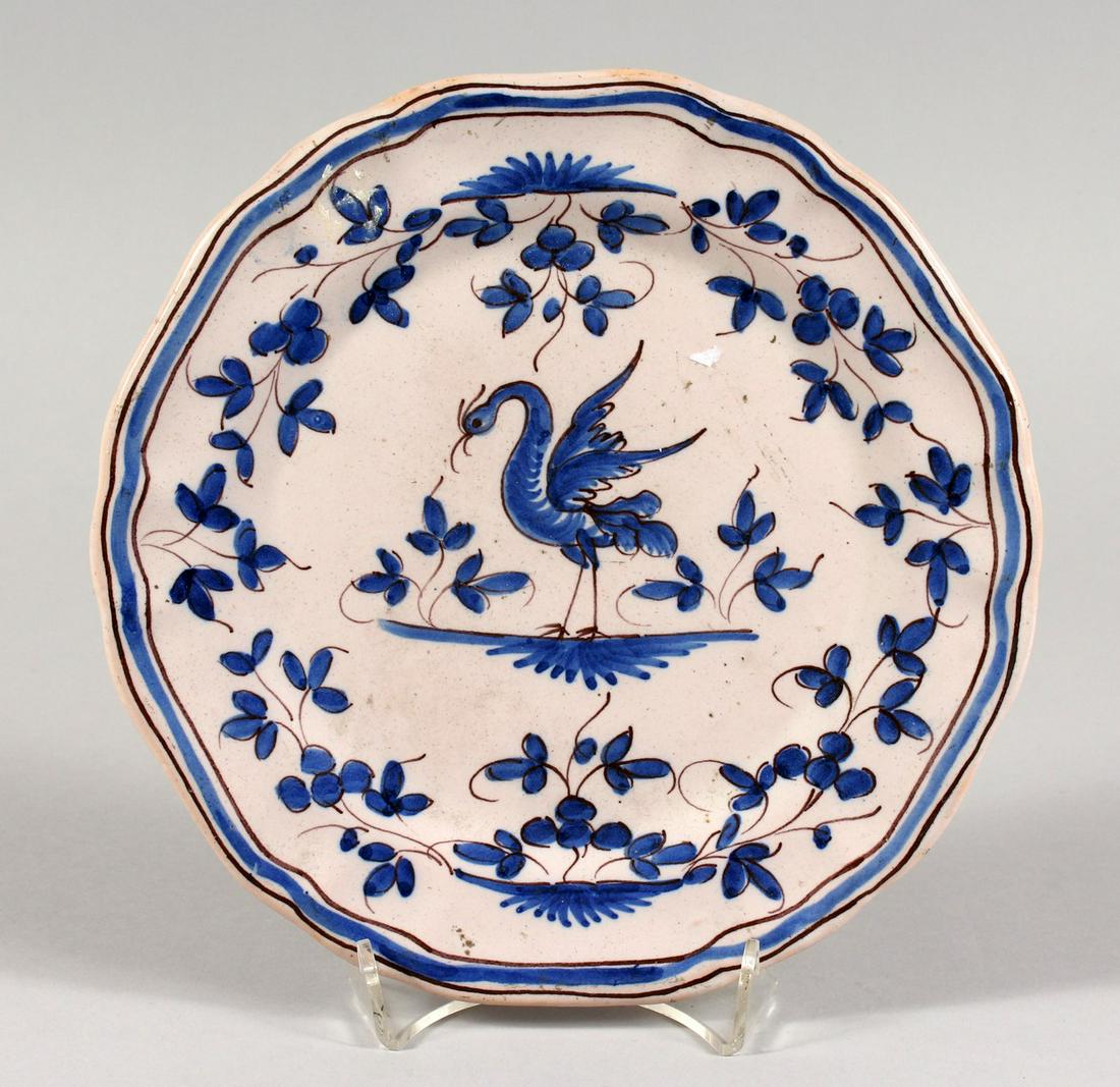 A FAIENCE BLUE AND WHITE PLATE with a crest. 8.5ins: A FAIENCE BLUE AND WHITE PLATE with a crest. 8.5ins diameter.