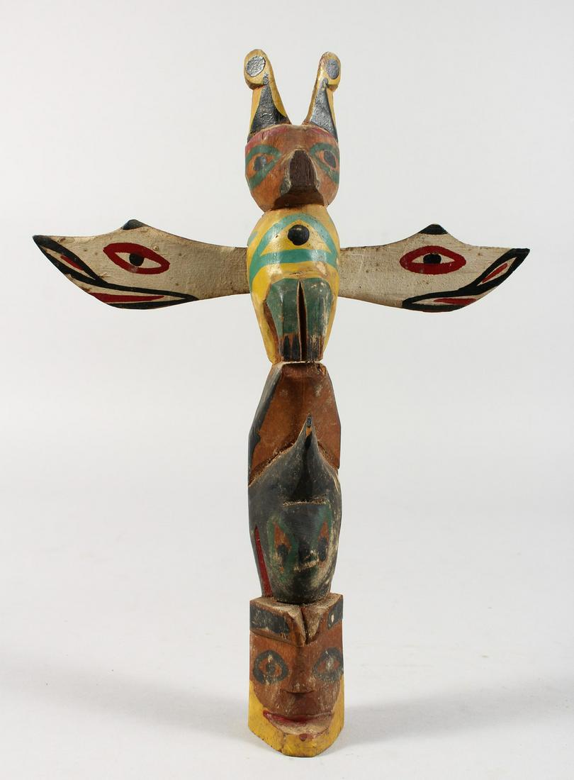 A CARVED OAK AND PAINTED FOLK ART THUNDERBIRD TOTEM: A CARVED OAK AND PAINTED FOLK ART THUNDERBIRD TOTEM POLE. 10ins long.