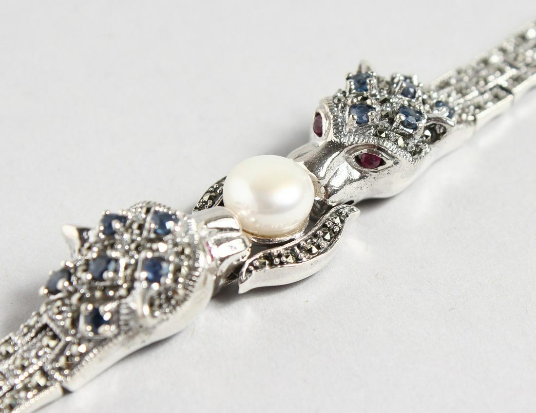 A GOOD SILVER AND SAPPHIRE PANTHER BRACELET with a: A GOOD SILVER AND SAPPHIRE PANTHER BRACELET with a large pearl.