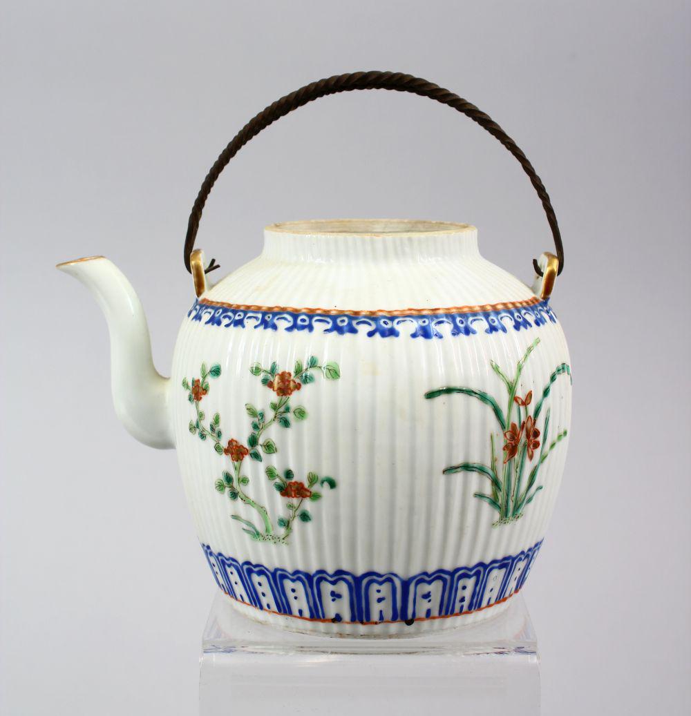 A 19TH CENTURY CHINESE FAMILLE ROSE PORCELAIN RIBBED: A 19TH CENTURY CHINESE FAMILLE ROSE PORCELAIN RIBBED TEAPOT, with floral decoration, 12cm high x 6cm