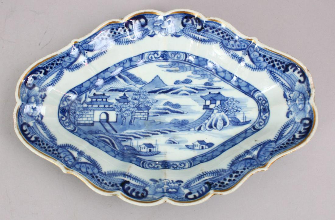 A GOOD 18TH CENTURY CHINESE QIANLONG BLUE & WHITE: A GOOD 18TH CENTURY CHINESE QIANLONG BLUE & WHITE PORCELAIN MOULDED DISH, decorated with typical lakeside landscape views, 27cm x 18cm.
