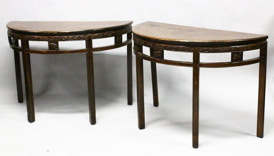 A FINE PAIR OF 18TH / 19TH CENTURY CHINESE CARVED: A FINE PAIR OF 18TH / 19TH CENTURY CHINESE CARVED HARDWOOD DEMI LUNE TABLES, the tops with a lovely aged patina, the frieze carved with deer and lion dogs, 105cm x 53cm ( each section )