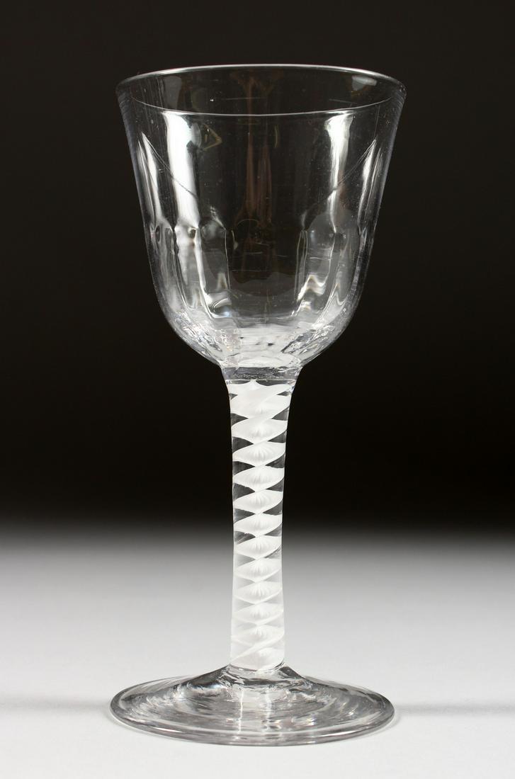 A LARGE GEORGIAN WINE GLASS with semi fluted bowl and: A LARGE GEORGIAN WINE GLASS with semi fluted bowl and white air twist stem, foot ground. 6ins high.
