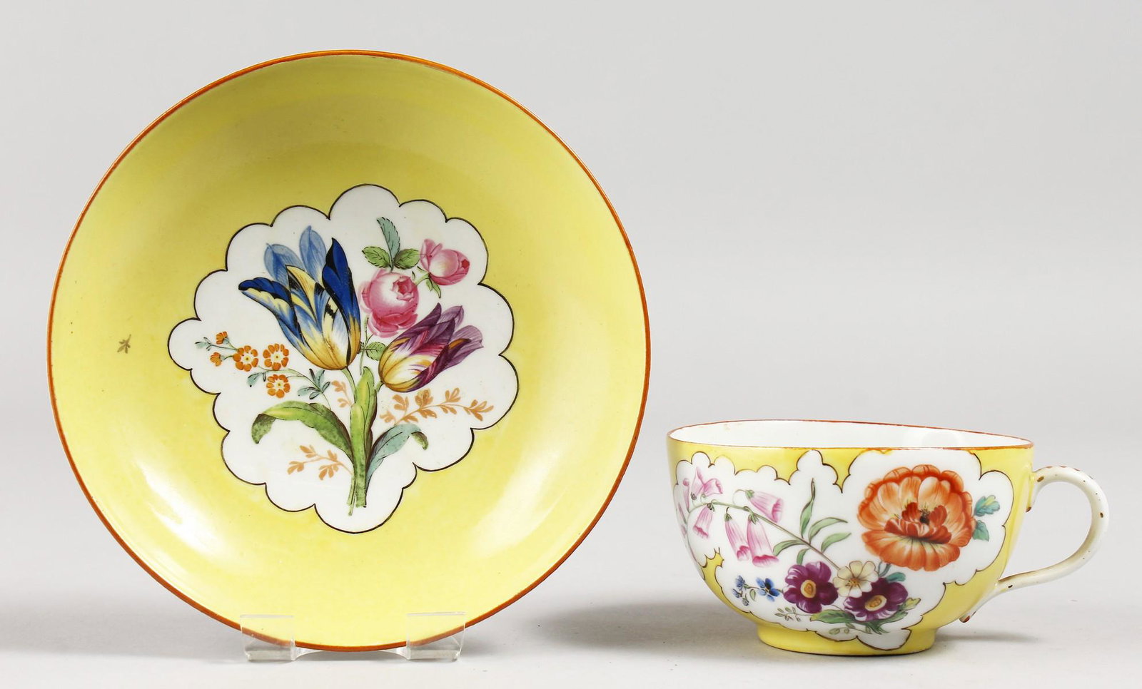A MEISSEN YELLOW GROUND CUP AND SAUCER painted with: A MEISSEN YELLOW GROUND CUP AND SAUCER painted with figures. Blue mark.