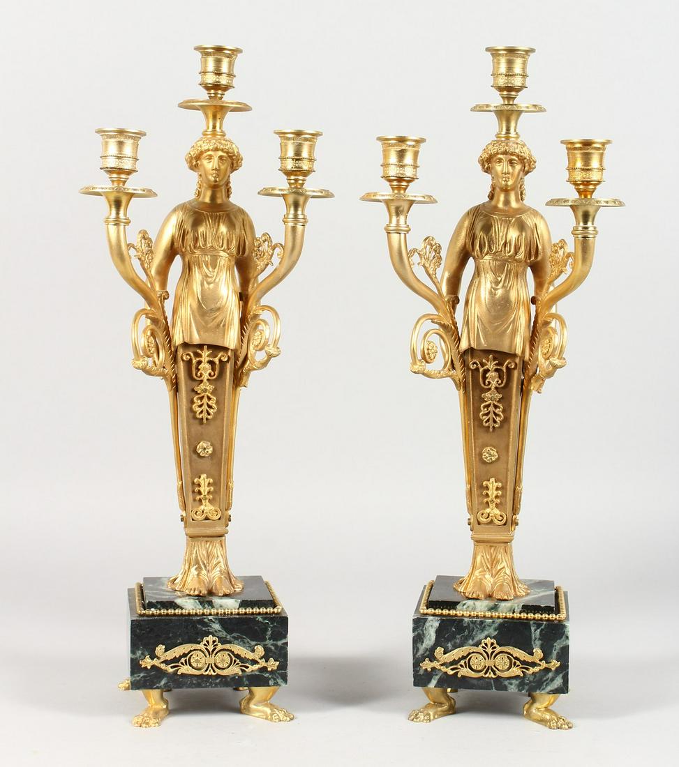 A PAIR OF EMPIRE REVIVAL GILT BRONZE AND MARBLE FIGURAL: A PAIR OF EMPIRE REVIVAL GILT BRONZE AND MARBLE FIGURAL CANDELABRA. 17ins high.