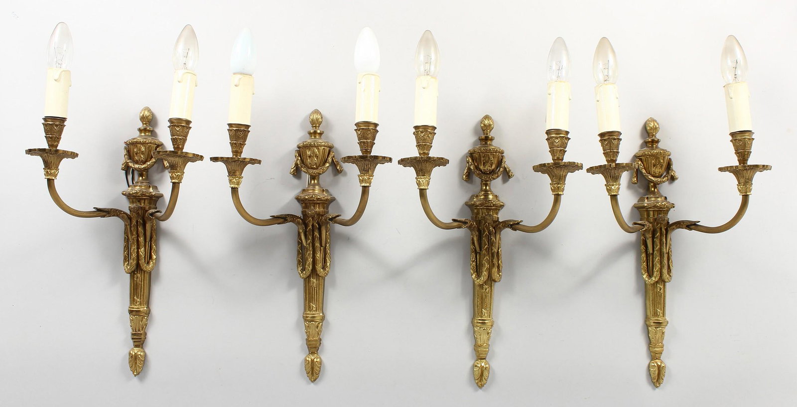 A SET OF FOUR ADAM REVIVAL ORMOLU TWIN-BRANCH WALL: A SET OF FOUR ADAM REVIVAL ORMOLU TWIN-BRANCH WALL APPLIQUES, with urn finials. 16ins high.