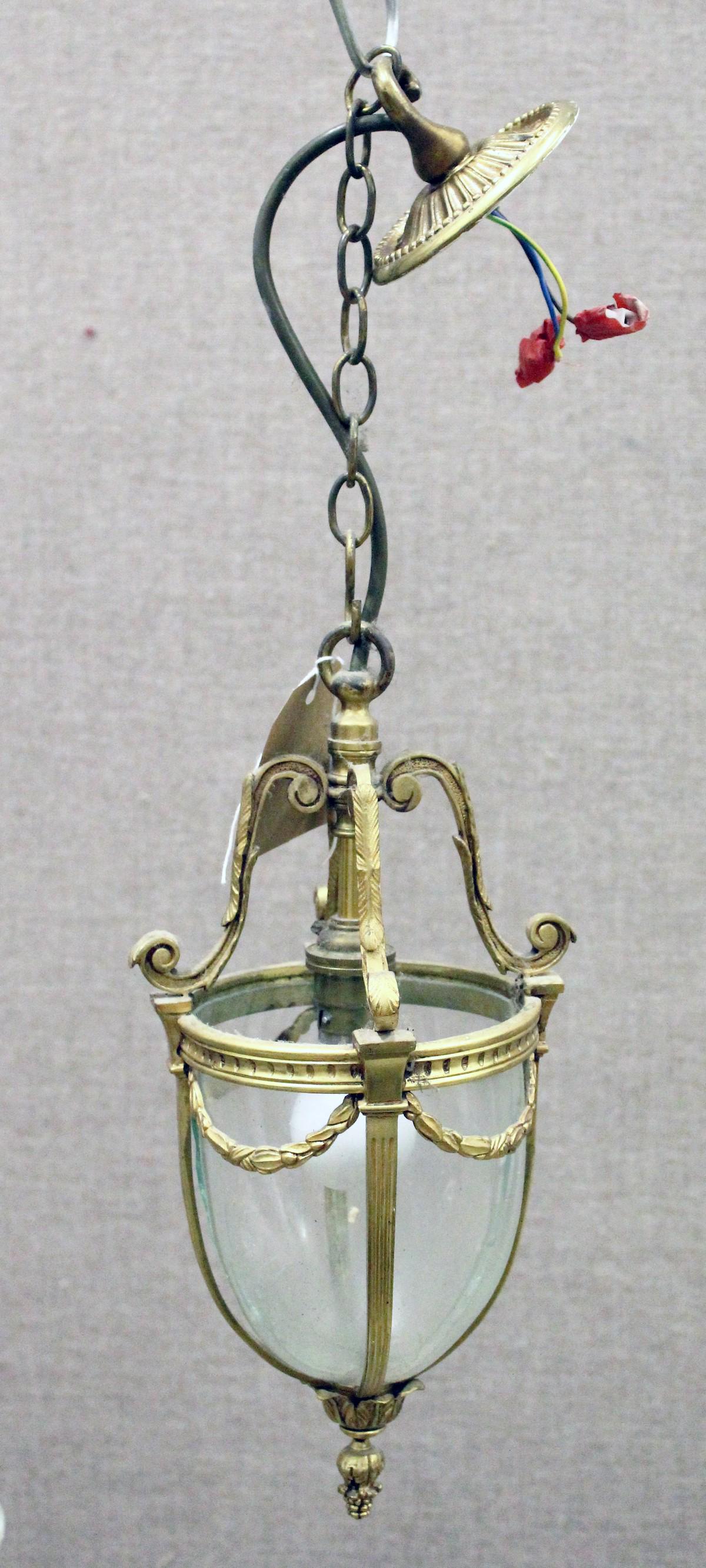 A SMALL BRASS AND GLASS HALL LANTERN, with four panels: A SMALL BRASS AND GLASS HALL LANTERN, with four panels of plain curving glass. 13ins high.