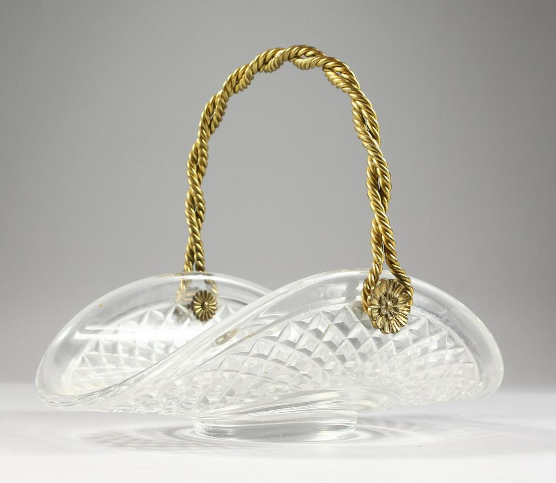 A GOOD CUT GLASS AND ORMOLU FLOWER BASKET, with swing: A GOOD CUT GLASS AND ORMOLU FLOWER BASKET, with swing handle. 10.5ins wide.