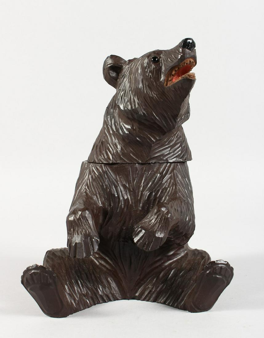 A BLACK FOREST CARVED WOOD BEAR CADDY. 8ins high.: A BLACK FOREST CARVED WOOD BEAR CADDY. 8ins high.