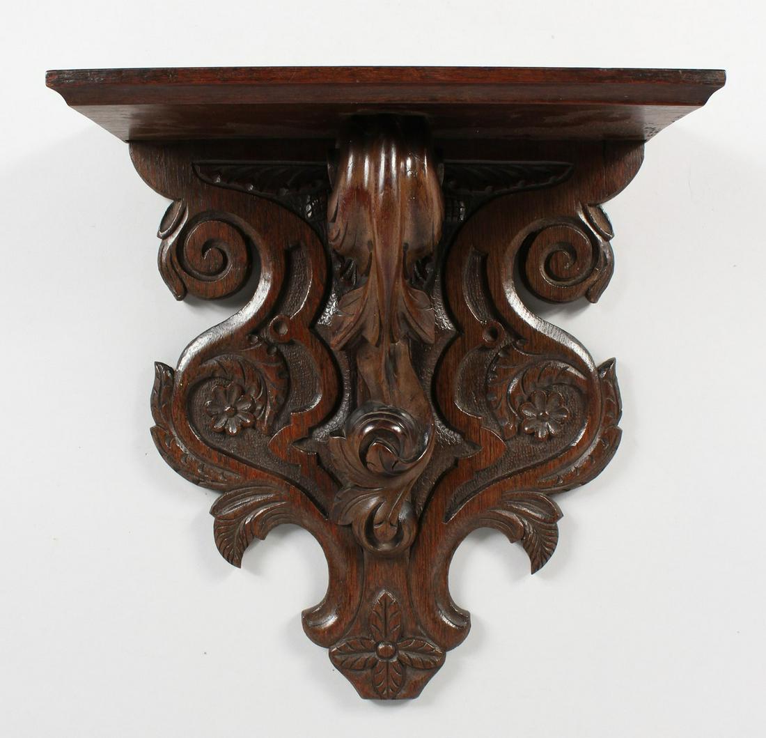 A CARVED OAK WALL BRACKET. 14.5ins high x 13.5ins wide: A CARVED OAK WALL BRACKET. 14.5ins high x 13.5ins wide x 6ins deep.