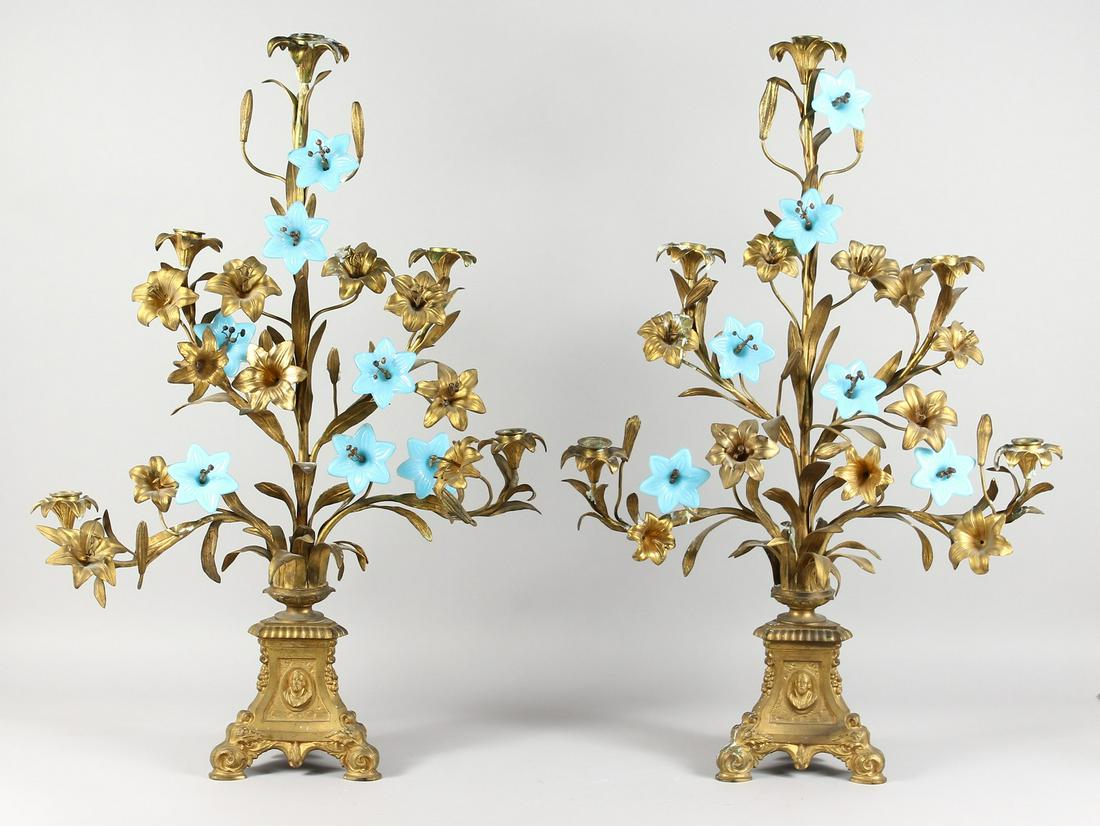 A PAIR OF 19TH CENTURY ORMOLU CANDELABRA, of: A PAIR OF 19TH CENTURY ORMOLU CANDELABRA, of naturalistic form, with leaves and flowers, the stems interspersed with blue opaque glass flower heads. 30ins high.