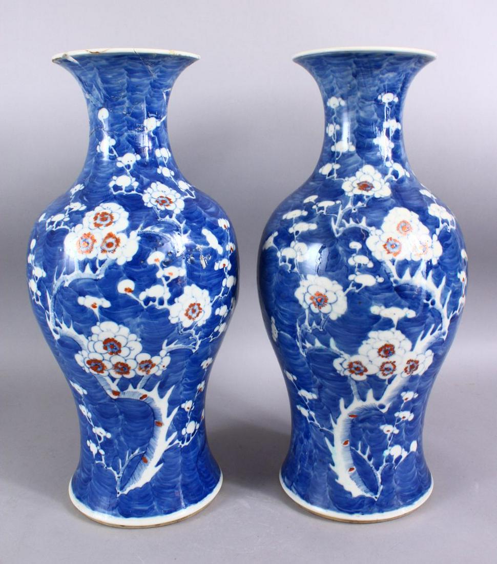 A PAIR OF 19TH CENTURY CHINESE BLUE & WHITE PORCELAIN: A PAIR OF 19TH CENTURY CHINESE BLUE & WHITE PORCELAIN PRUNUS VASES, each with prunus decoration, the bases with six character kangxi marks. 46cm high (af)