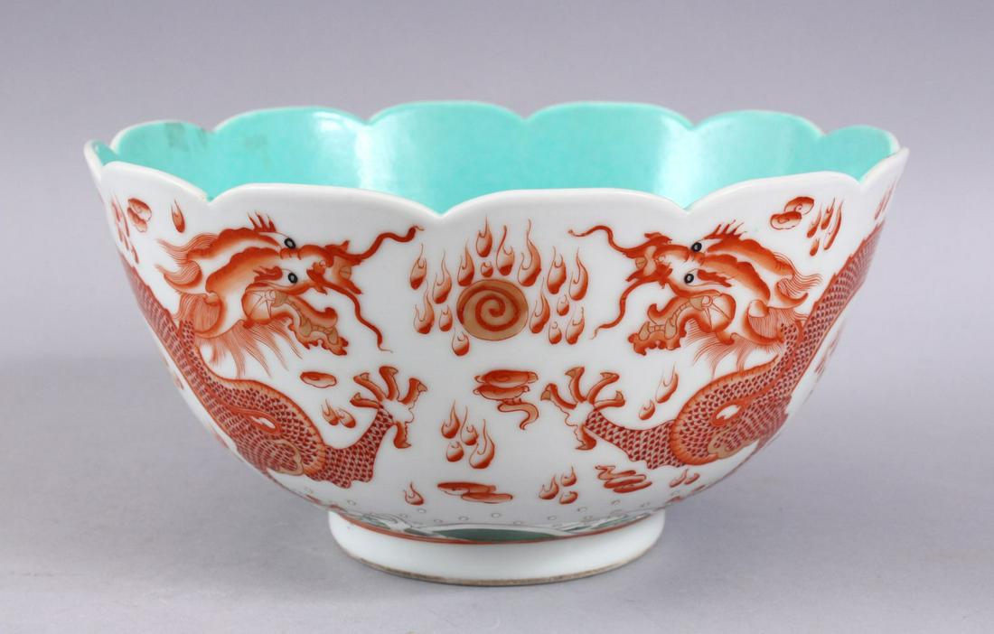 A CHINESE IRON RED & TURQUOISE PORCELAIN MOULDED BOWL,: A CHINESE IRON RED & TURQUOISE PORCELAIN MOULDED BOWL, with iron red decorated dragons with green wave design, the interior and base with turquoise glaze and bearing a six character qianlong mark, 22c