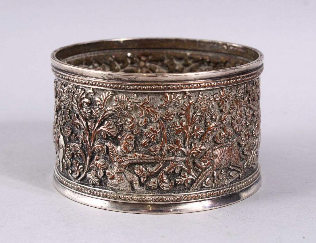 A GOOD ELKINGTON INDIAN SCENE SILVERED BOTTLE COASTER,: A GOOD ELKINGTON INDIAN SCENE SILVERED BOTTLE COASTER, with hunting scenes and floral decoration, hallmark to base, 10cm