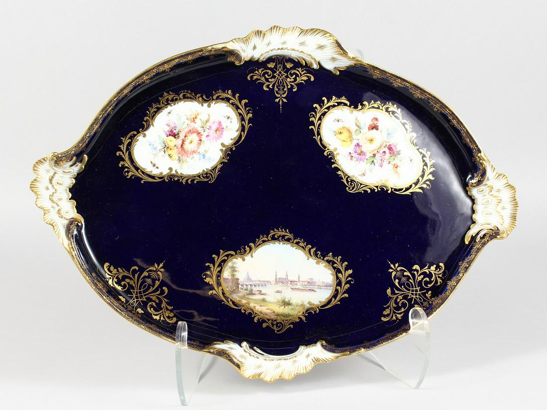 A SUPERB MEISSEN OVAL SHAPED TRAY, rich blue ground: A SUPERB MEISSEN OVAL SHAPED TRAY, rich blue ground painted with panels of flowers and Dresden. Cross swords mark in blue. 17.5ins long x 12ins wide. Note: It is the tray to Lot 1199, 8th October Auct