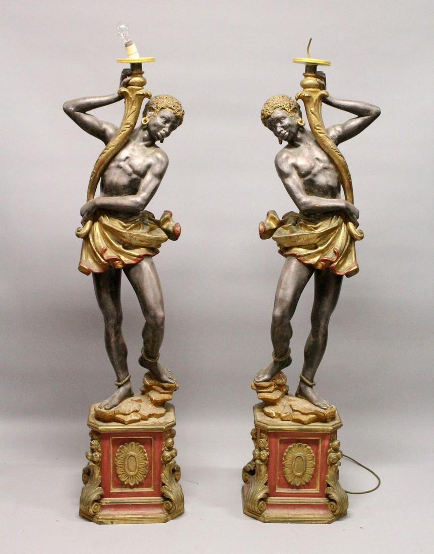 A PAIR OF PAINTED COMPOSITE BLACKAMOOR FLOOR STANDING: A PAIR OF PAINTED COMPOSITE BLACKAMOOR FLOOR STANDING SEVEN LIGHT CANDELABRA. 7ft 0ins high.