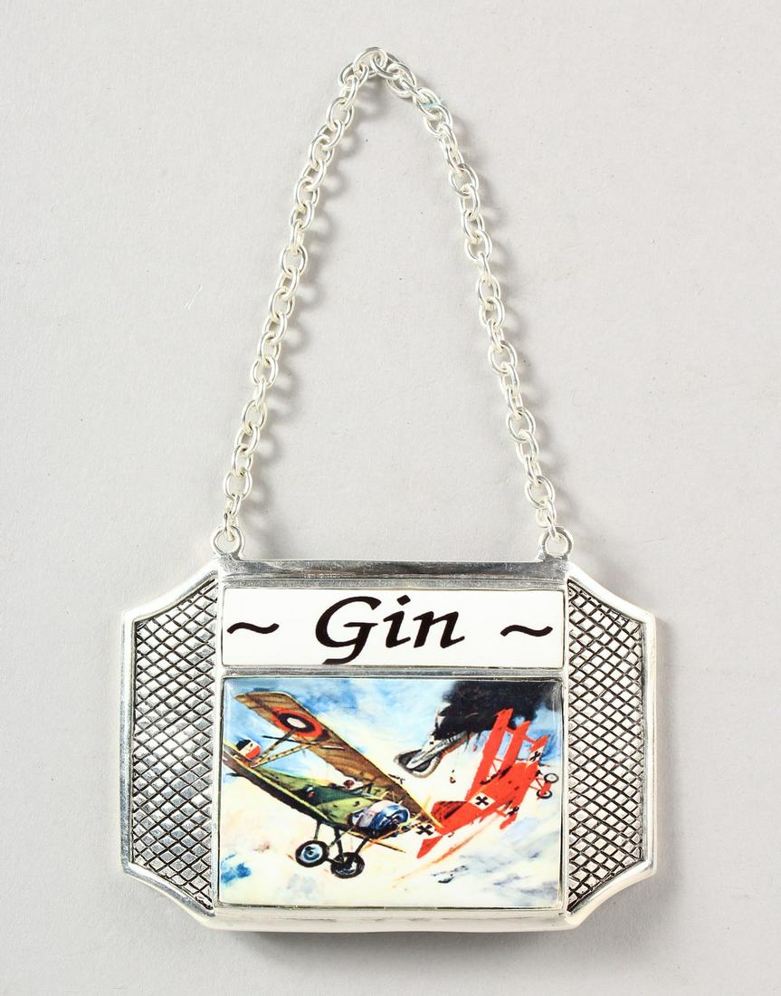 A SILVER PLATED DECANTER LABEL "GIN", enamel decorated: A SILVER PLATED DECANTER LABEL "GIN", enamel decorated with an aeronautical dog fight including "The Red Baron" Manfred von Richthofen in his Fokker tri-plane.