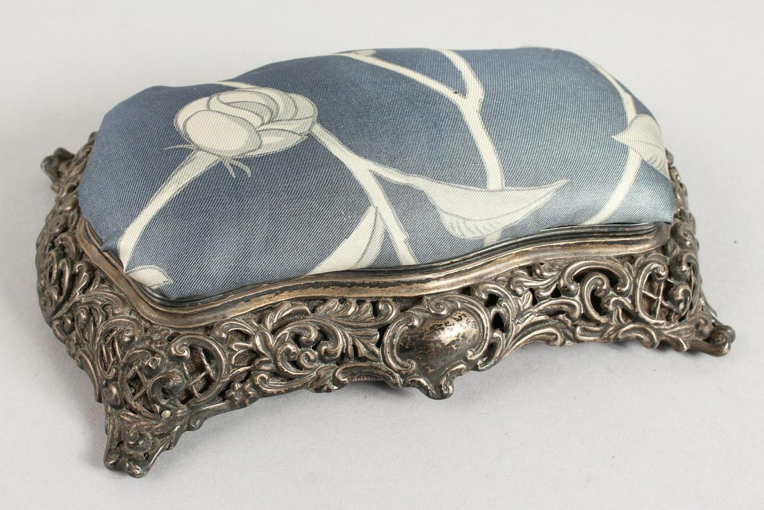 A VICTORIAN PIERCED SILVER PIN CUSHION with padded top: A VICTORIAN PIERCED SILVER PIN CUSHION with padded top and blue silk interior. Birmingham 1896.