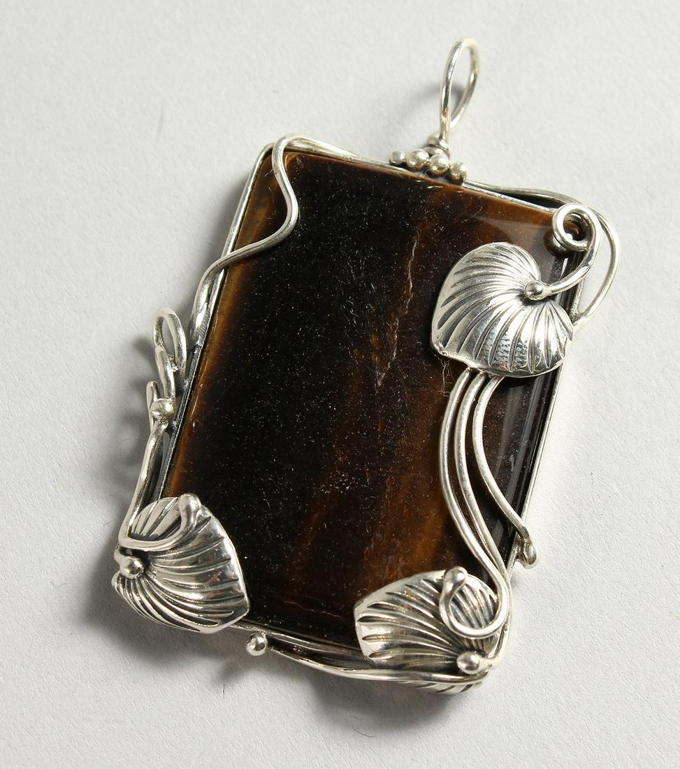 A SILVER AND TIGER'S EYE PENDANT.: A SILVER AND TIGER'S EYE PENDANT.