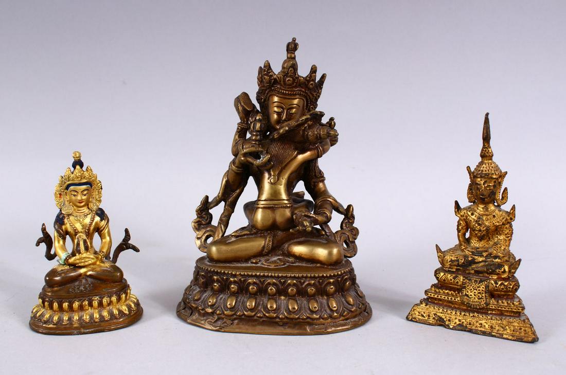THREE TIBETAN GILT BRONZE FIGURES, each with varying: THREE TIBETAN GILT BRONZE FIGURES, each with varying pose, the smallest with poly chrome decoration, impressed mark to base, 10cm, one gilt bronze with legs and arms crossed, possibly 18th century, 13