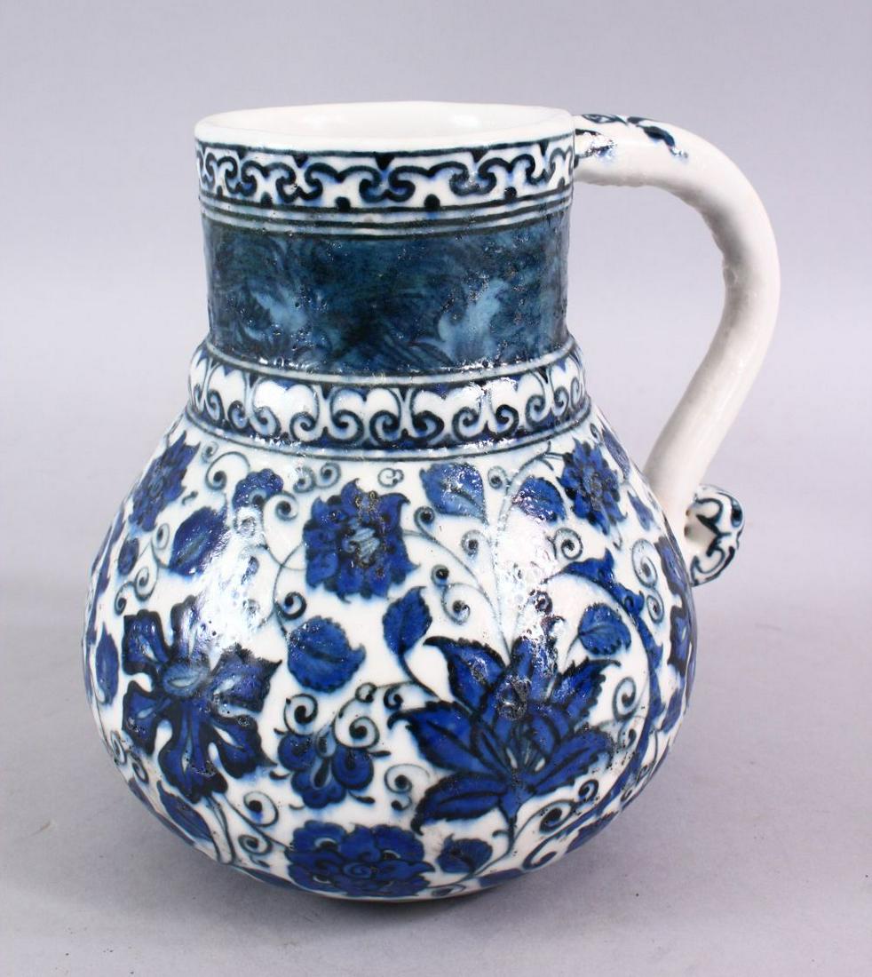 AN ISLAMIC BLUE & WHITE PORCELAIN WATER JUG, decorated: AN ISLAMIC BLUE & WHITE PORCELAIN WATER JUG, decorated with formal scrolling flora, 20cm high.