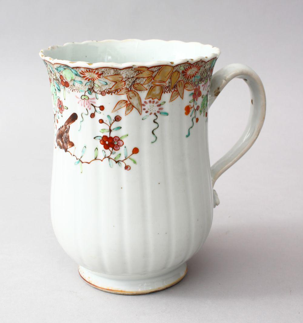 A GOOD 18TH CENTURY CHINESE QIANLONG FAMILLE ROSE: A GOOD 18TH CENTURY CHINESE QIANLONG FAMILLE ROSE PORCELAIN TANKARD, the body of the moulded tankard decorated with scenes of native floral borders, 16cm high x 16cm wide.