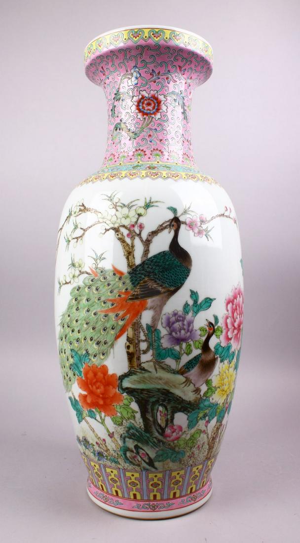 A LARGE CHINESE REPUBLIC STYLE FAMILLE ROSE PORCELAIN: A LARGE CHINESE REPUBLIC STYLE FAMILLE ROSE PORCELAIN VASE, decorated with peacocks amongst blossom trees and other native flora, with calligraphy, ruyi borders and two seal marks at the base, 61cm.