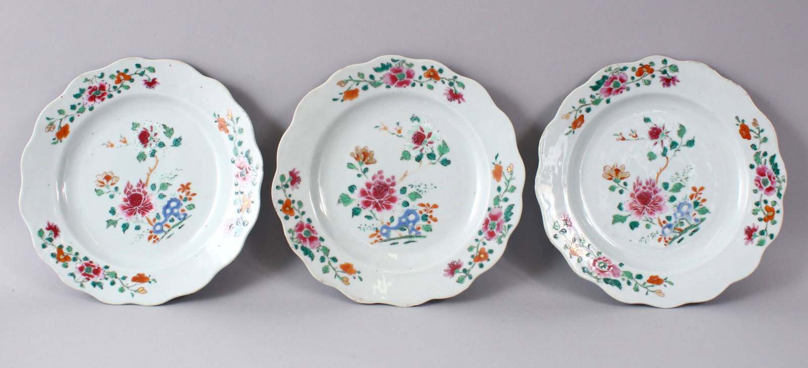 THREE 18TH CENTURY CHINESE FAMILLE ROSE FLORAL: THREE 18TH CENTURY CHINESE FAMILLE ROSE FLORAL DECORATED PLATES, 22.5CM.