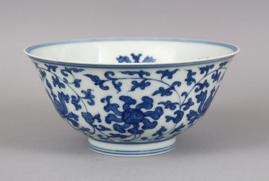 A CHINESE BLUE & WHITE FLORAL DECORATED PORCELAIN BOWL,: A CHINESE BLUE & WHITE FLORAL DECORATED PORCELAIN BOWL, with formal floral motif, the base with a six character mark, 15.5cm.