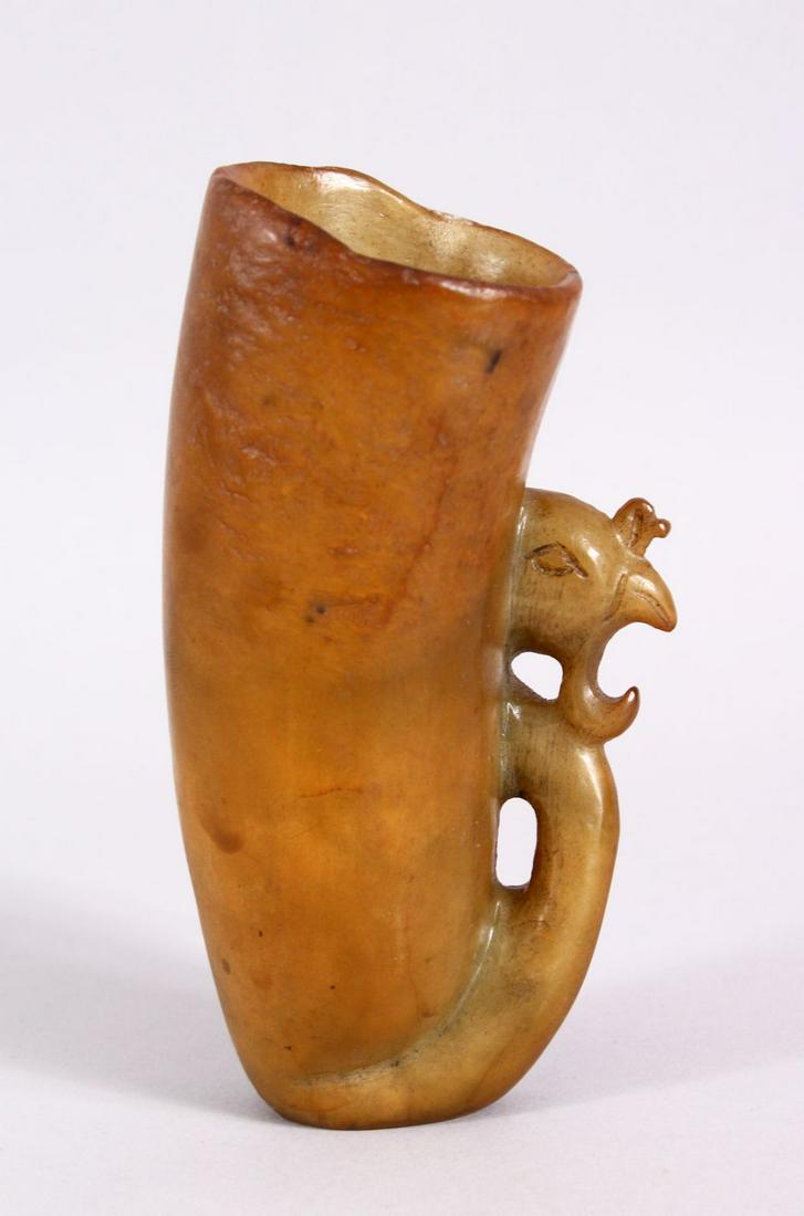 A CHINESE 20TH CENTURY CARVED SOAPSTONE LIBATION CUP,: A CHINESE 20TH CENTURY CARVED SOAPSTONE LIBATION CUP, with a phoenix head carved handle, 15cm high.