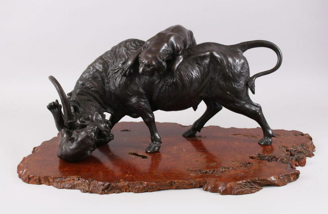 A LARGE AND HEAVY JAPANESE MEIJI PERIOD BRONZE OXEN &: A LARGE AND HEAVY JAPANESE MEIJI PERIOD BRONZE OXEN & TIGER GROUP, the artist has captured in realistic detail the moment two tigers attack an oxen, one upon his back and the other attacking the face 
