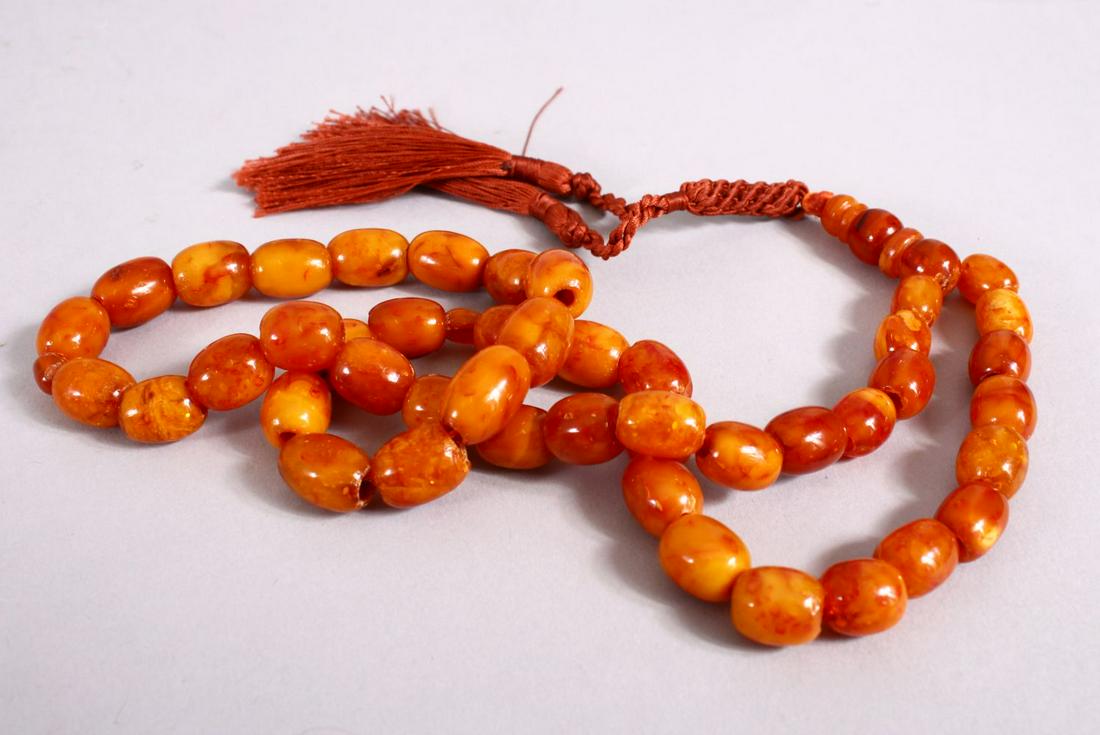 A 19TH CENTURY ISLAMIC CARVED AMBER PRAYER BEAD (1 of 3)