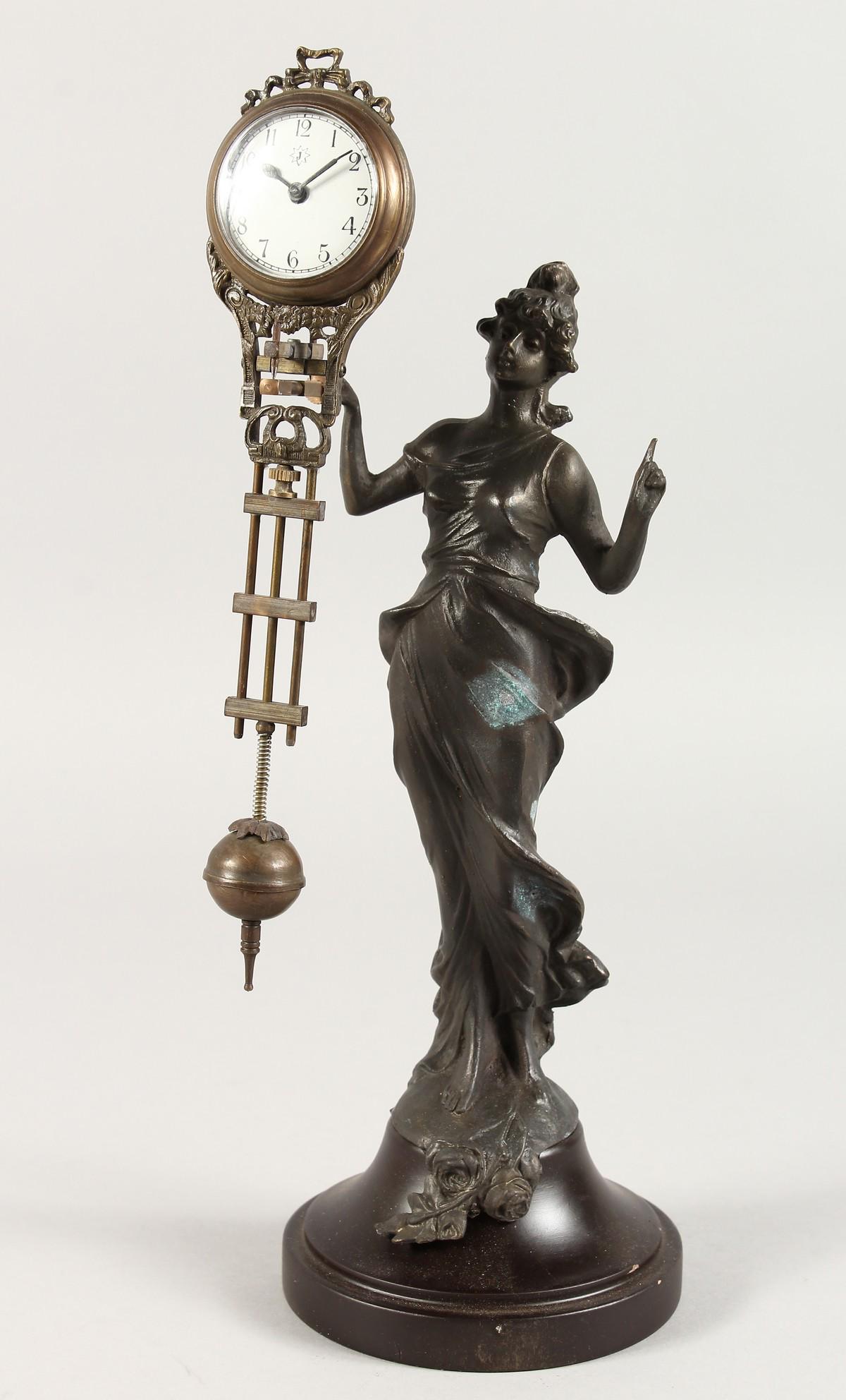 AN ART NOUVEAU STYLE MYSTERY CLOCK OF A STANDING LADY: AN ART NOUVEAU STYLE MYSTERY CLOCK OF A STANDING LADY on a circular base. 11ins high.