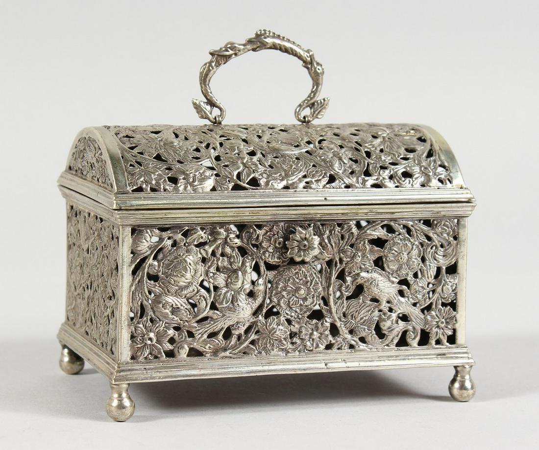 A GOOD DUTCH SILVER DOMED TOP MARRIAGE CASKET, with: A GOOD DUTCH SILVER DOMED TOP MARRIAGE CASKET, with pierced panels, flowers and birds with swan swing handle, supported on four ball feet. 3.75in slong x 2.5ins wide x 3ins high.