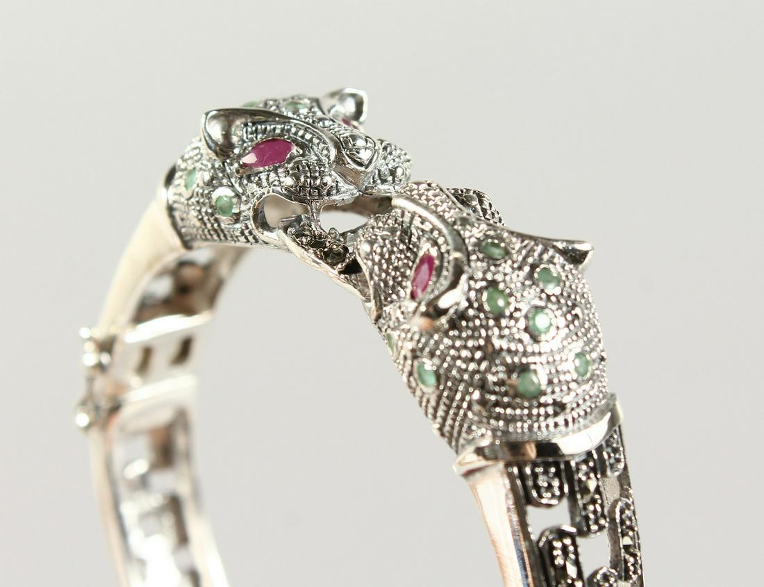 A SILVER, RUBY AND EMERALD PANTHER BRACELET.: A SILVER, RUBY AND EMERALD PANTHER BRACELET.