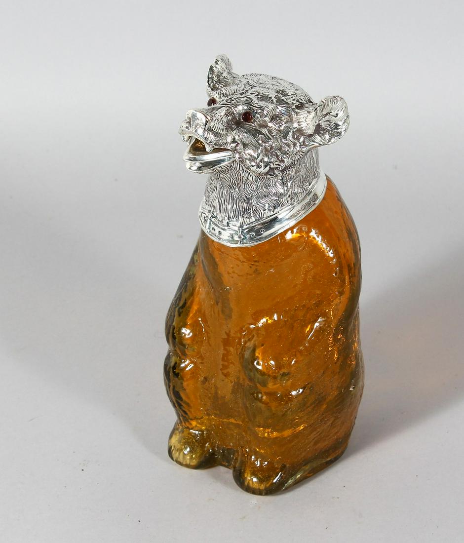 A GOOD AMBER GLASS BEAR CLARET JUG with plated head and: A GOOD AMBER GLASS BEAR CLARET JUG with plated head and collar. 9ins high.