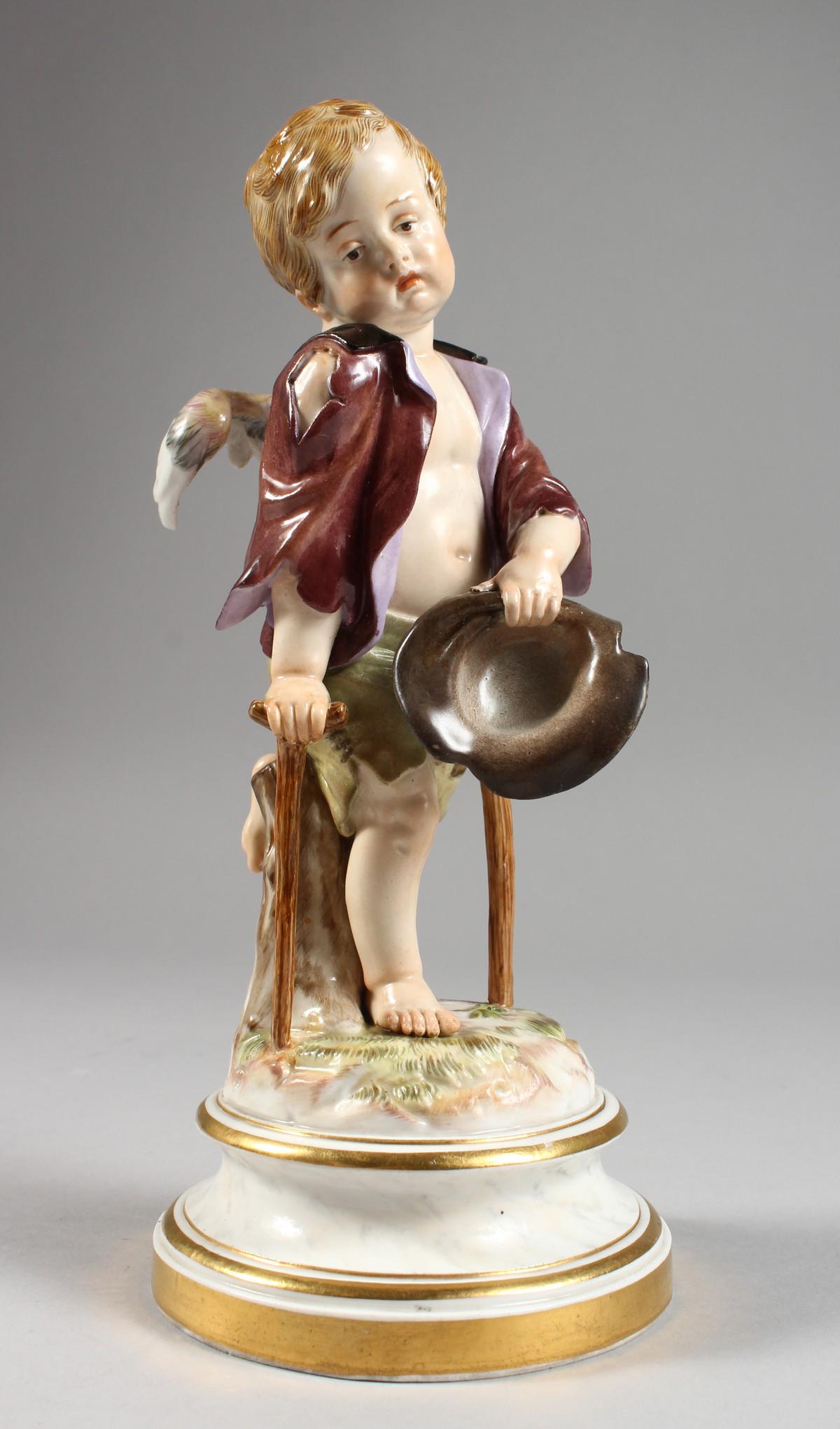 A MEISSEN PORCELAIN FIGURE OF A CHERUB holding a hat: A MEISSEN PORCELAIN FIGURE OF A CHERUB holding a hat and walking with a stick. Cross swords mark in blue. Impressed No. 138. 8ins high.