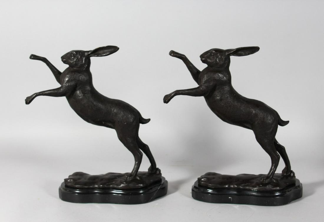 A GOOD PAIR OF BRONZE BOXING HARES on a shaped marble: A GOOD PAIR OF BRONZE BOXING HARES on a shaped marble base. 11ins high.
