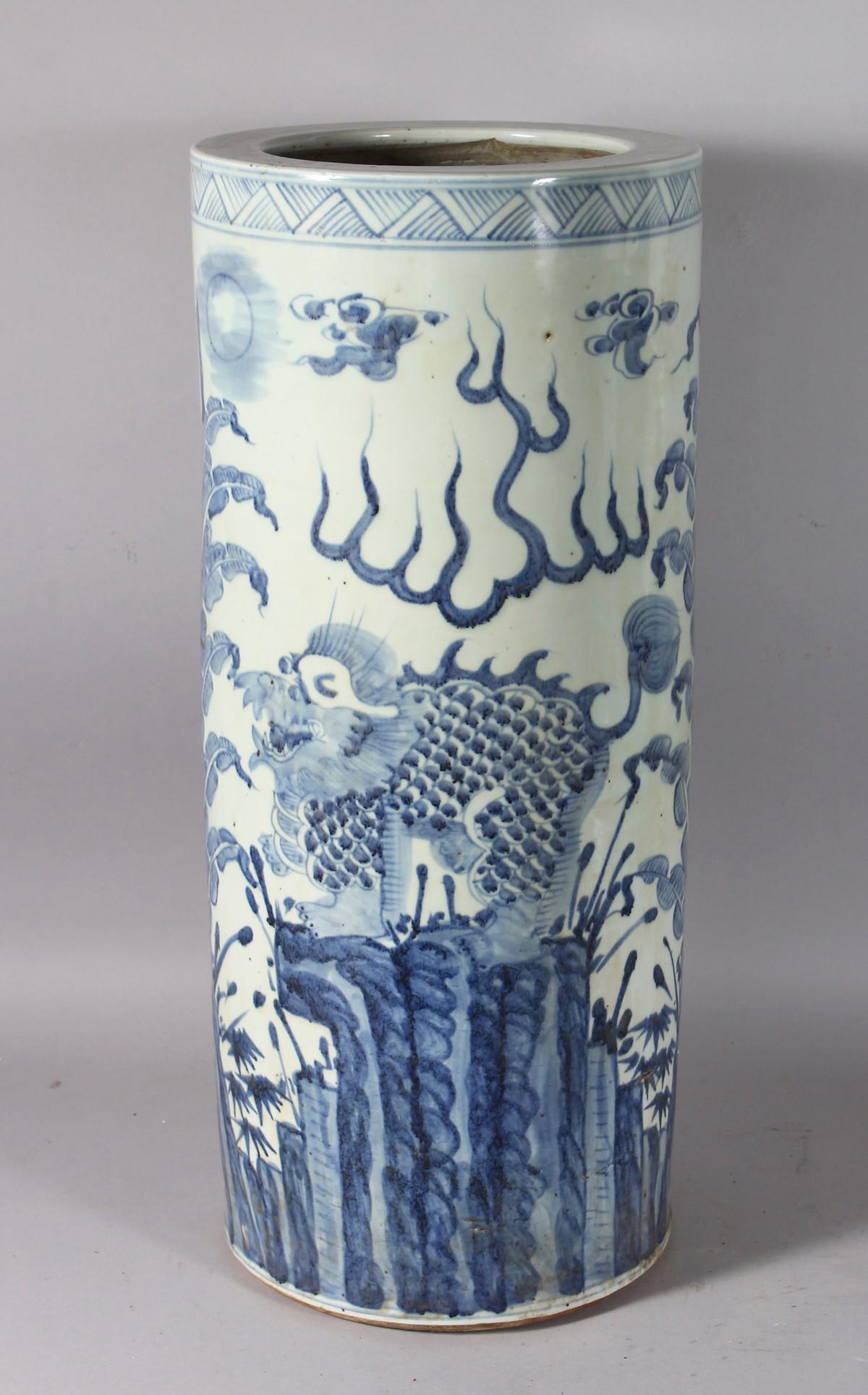 A CHINESE BLUE AND WHITE UMBRELLA STAND, dragon: A CHINESE BLUE AND WHITE UMBRELLA STAND, dragon decoration. 24ins high.