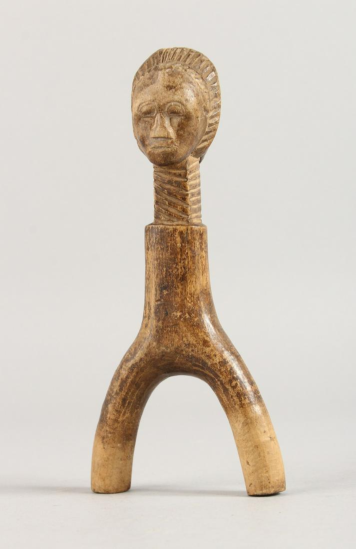 AN AFRICAN CARVED WOOD FIGURE. 8ins long.: AN AFRICAN CARVED WOOD FIGURE. 8ins long.
