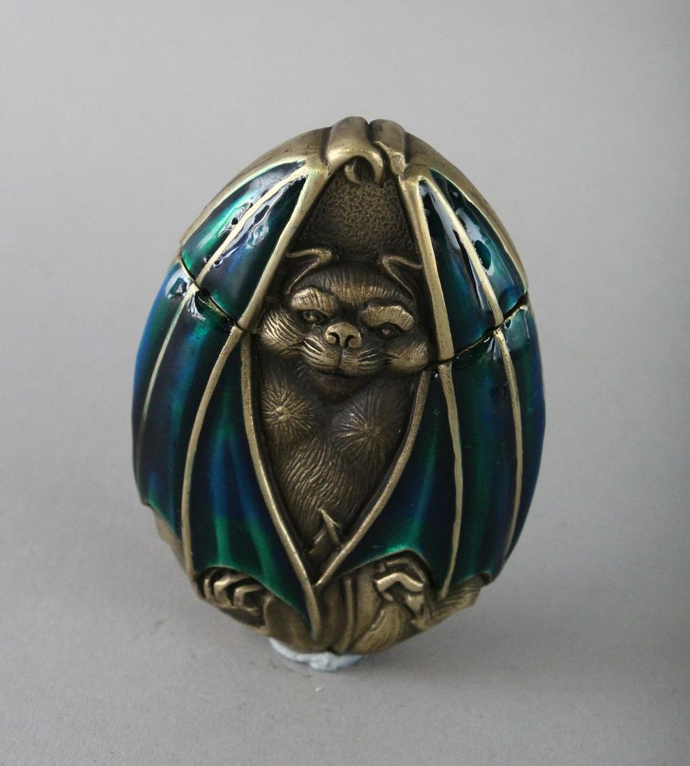 A BRASS AND ENAMEL BAT VESTA. 2.5ins.: A BRASS AND ENAMEL BAT VESTA. 2.5ins.