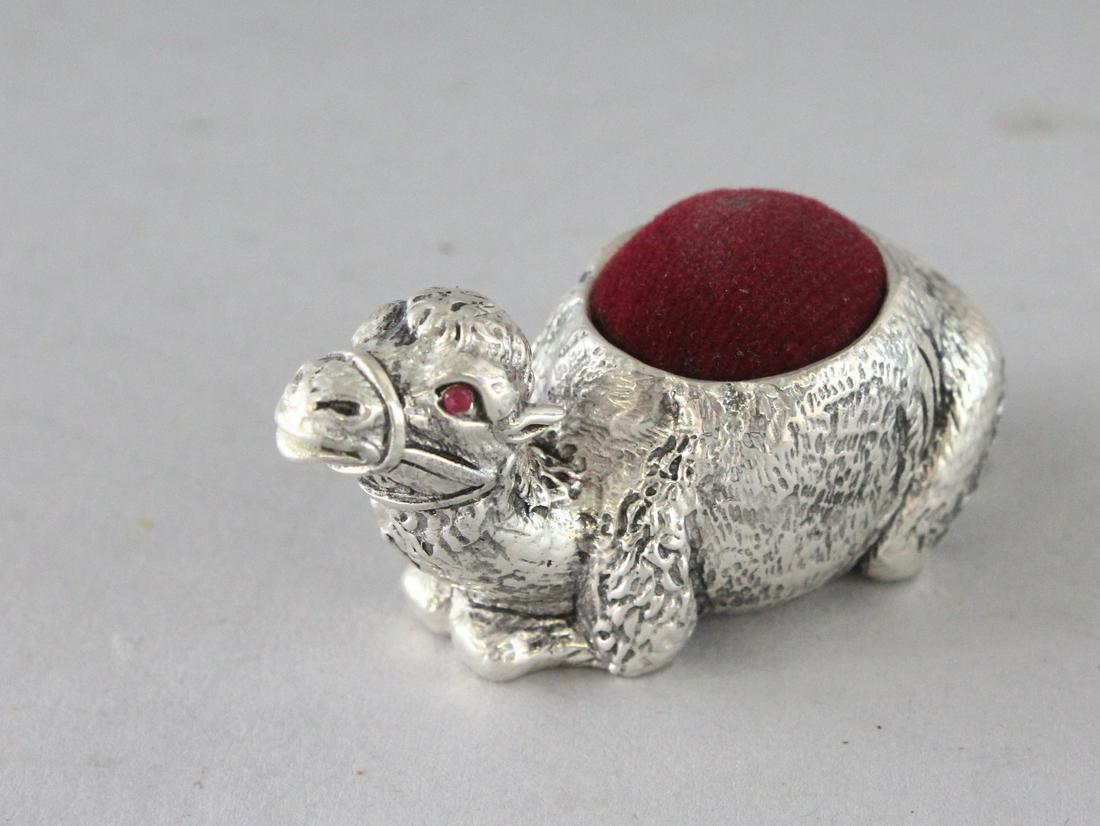 A PLATED CAMEL PIN CUSHION. 2.25ins: A PLATED CAMEL PIN CUSHION. 2.25ins