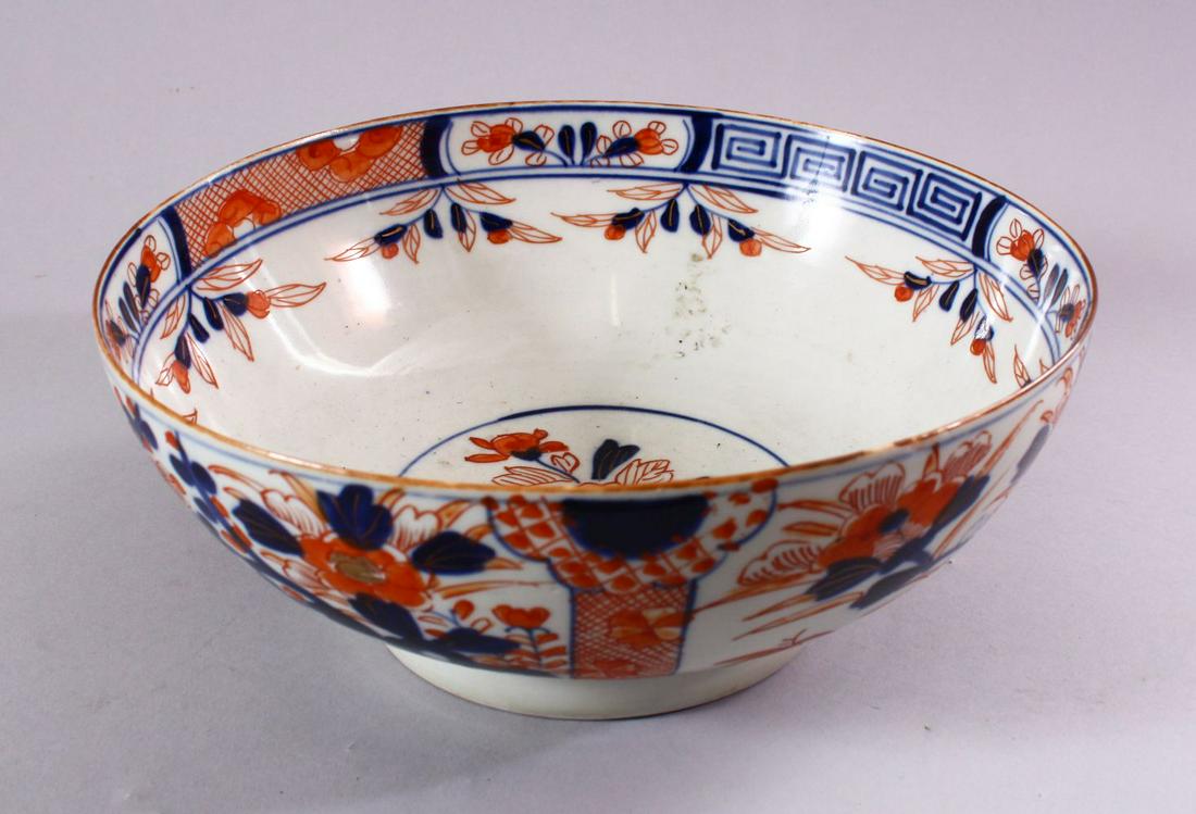 A JAPANESE EDO / MEIJI PERIOD IMARI PORCELAIN BOWL,: A JAPANESE EDO / MEIJI PERIOD IMARI PORCELAIN BOWL, decorated with panel displays of native flora and trees, 25.5cm