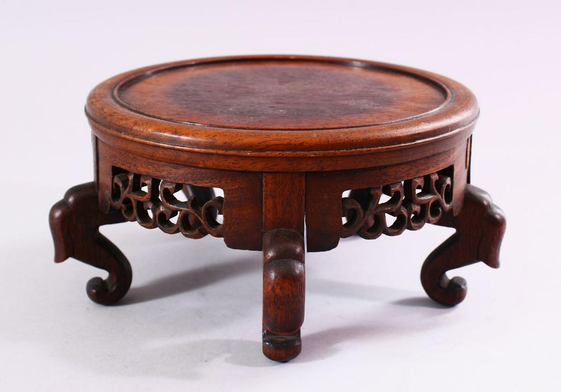 A 19TH CENTURY CHINESE CARVED HARDWOOD STAND, with (1 of 3)