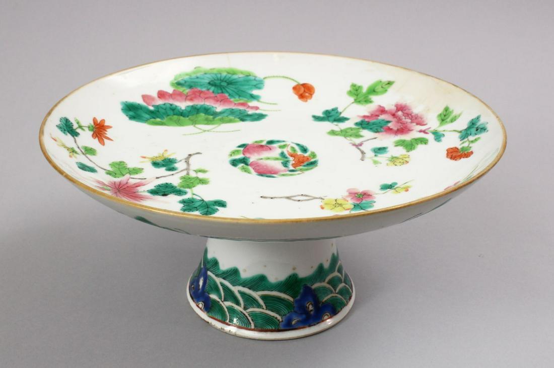 A 19TH CENTURY CHINESE FAMILLE ROSE PORCELAIN STEM: A 19TH CENTURY CHINESE FAMILLE ROSE PORCELAIN STEM DISH, decorated with native array of flora with a lower band of waves and bats, (af) 24cm
