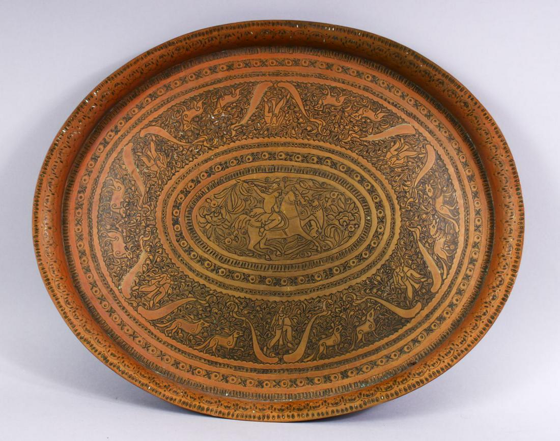 A HEAVY QUALITY CARVED PERSIAN BRASS TRAY, carved with (1 of 7)