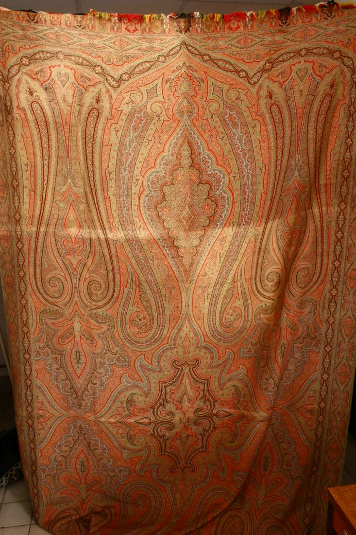 A LARGE PAISLEY BED COVER OR THROW, of typical form,: A LARGE PAISLEY BED COVER OR THROW, of typical form, 320cm x 155cm.