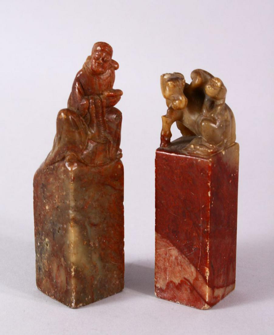 A PAIR OF 19TH / 20TH CENTURY CHINESE CARVED SOAPSTONE: A PAIR OF 19TH / 20TH CENTURY CHINESE CARVED SOAPSTONE SEALS, one of monkeys upon horse, the other of a man seated upon a rock, both uncarved bases, 9.5cm & 10.5cm